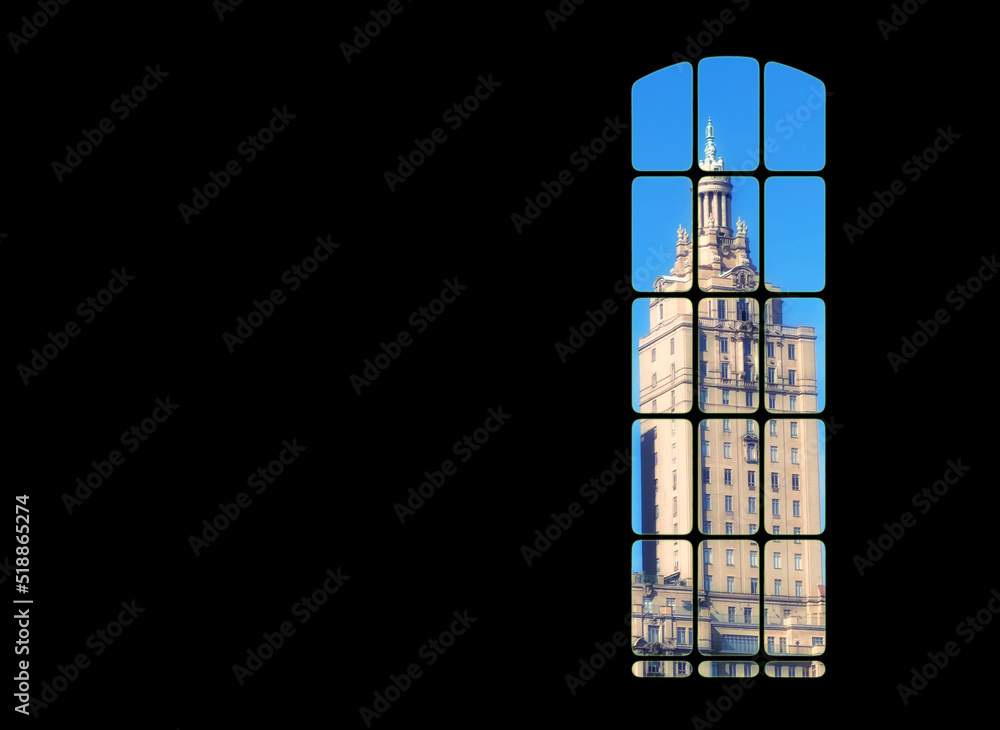 Poster view from inside big window grid looking out at a traditional skyscraper building on blue sky copy s