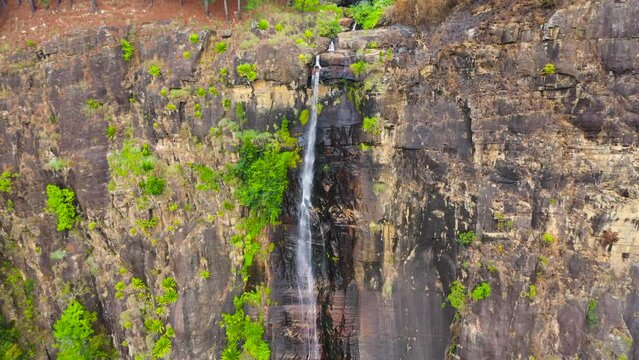 Aerial view of waterfall in the rainforest. Bambarakanda Falls in the tropical mountain jungle. Sri Lanka.