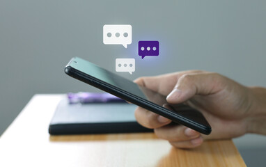 Women hand using smartphone typing, chatting conversation in chat box icons pop up. Social media maketing concept.