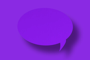Purple paper in the shape of speech bubbles against a purple background. Communication bubbles.