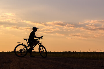 Fototapeta na wymiar boy on bicycles. summer healthy lifestyle. sunset holidays. copy space.