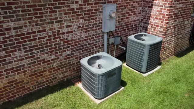 Air conditioners next to brick house