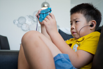 asian chinese boy playing smartphone, kid use phone and play game, addicted game and cartoon
