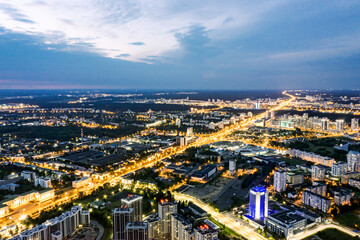 aerial panoramic view of the illuminated city streets and buildings at sunset