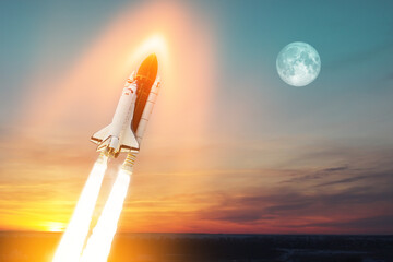 Spaceship lift off. Space shuttle with smoke and blast takes off into space on a background of a...