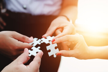 business strategy ideas Business team planning a strategic meeting Assembling jigsaw pieces, using...