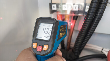 temperature measurement on the main power cable of the electrical panel using a digital infrared...