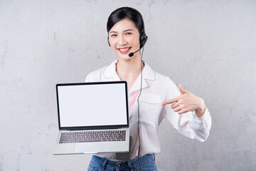 Portrait of young Asian operator on background