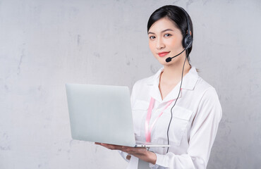 Portrait of young Asian operator on background