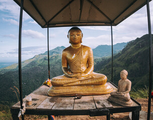Piękny posąg Buddy, na tle krjaobrazu gór.