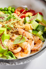 Bowl of couscous with shrimp and vegetables