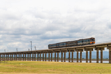 The train is running on floating railway track that passes through the grasslands at Pa Sak Jolasid Dam.Thailand.