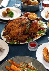 Traditional holiday dinner for celebration Thanksgiving. Baked chicken, potatoes and sides. Family party or gathering. Fall table setting. Top view table scene