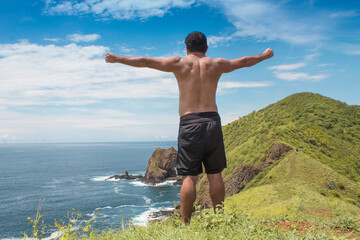 man admiring the ocean view on a green island in Costa Rica