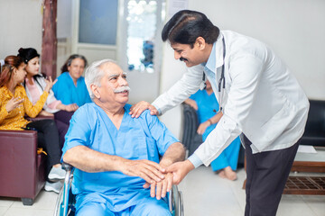Obraz premium alzheimer, Indian doctor support disabled old man patient sit on wheelchair at hospital, paralyzed old people healthcare concept. Caregiver. 