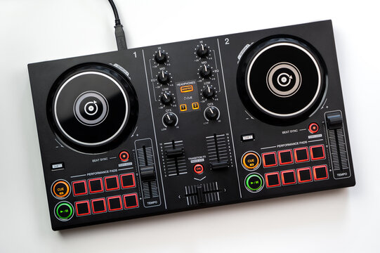 DJ Colorful mixing deck Controller connecting to Laptop and tablet using USB cable top view, isolated on white.