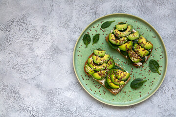 Toast with avocado, cottage cheese, spinach, sesame seeds, flax seeds. Healthy food rich in fiber, trace elements, omega acids, unsaturated lipids.