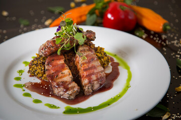 Typical dish of Peru, alpaca loin on a restaurant table.