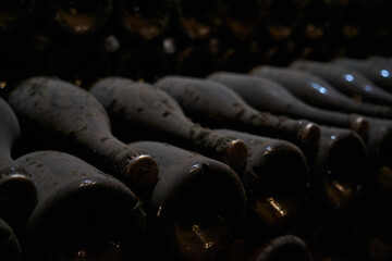 Image of wine bottles in an underground tunnel for aging wine.