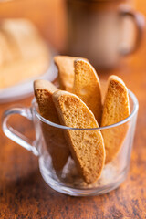 Sweet anicini cookies. Italian biscotti with anise flavor in cup on wooden table.