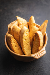 Sweet anicini cookies. Italian biscotti with anise flavor in bowl on black table