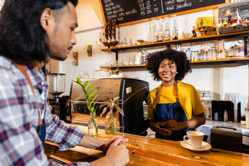Fototapeta premium Portrait Of Smiling Couple Running Coffee Shop Together Standing Counter.Happy waiter and waitress posing in cafe. Small business concept.