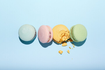multicolored macaroons on a blue background. top view