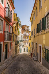 Fototapeta na wymiar Colorful narrow street in Lisbon, Portugal
