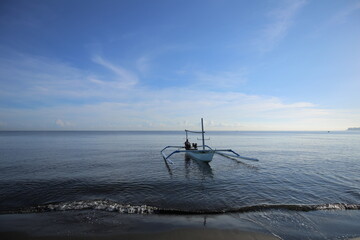 Typical Indonesian fishing boat at the Pacific Ocean. Fishing boat is for tourists to go to dolphin...