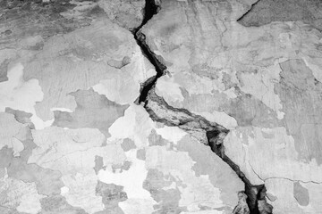 Big winding crack on old wall, abstract image of cleft. Black and white photo. Close-up. Copy space. Selective focus.