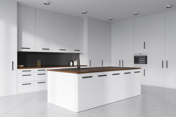 Light kitchen interior with countertop and kitchenware, grey concrete floor