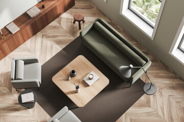 Top view of light lounge interior with chairs and couch, drawer and window