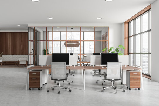 Office interior with pc computer, relax area and panoramic window on city view