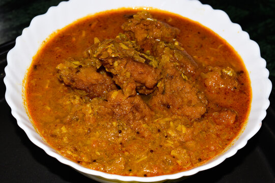 Indian Traditional Cuisine chana dal pakodi or kachri in curry in white bowl