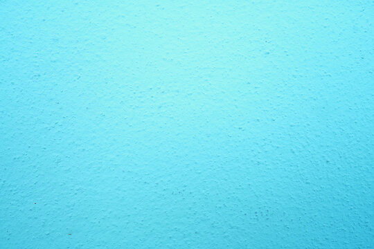 abstract, rough plaster wall texture is light blue for backgroun