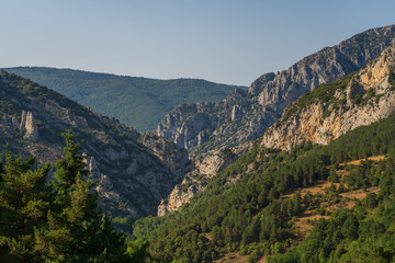 Fototapeta na wymiar Scenic late afternoon summer landscape of the Boulzane river valley in the French Pyrenees mountain range, Salvezines, Aude, France
