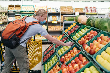 Tired or bored child in shopping center, Girl sitting in the cart in front of cash register in grocery store 11.02.2021- Hurghada, Egypt