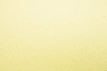 Abstract Rough plaster wall golden yellow for background blurry