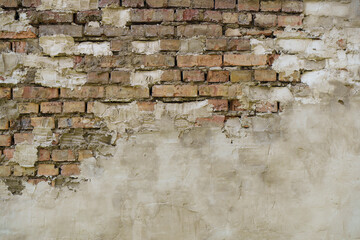 Old brick wall. Brickwork from an old brick in a rustic style. The structure and pattern of the destroyed stone wall. Copy space 