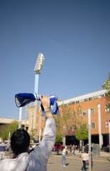 Unrecognizable Woman supporting the team before entering the stadium.