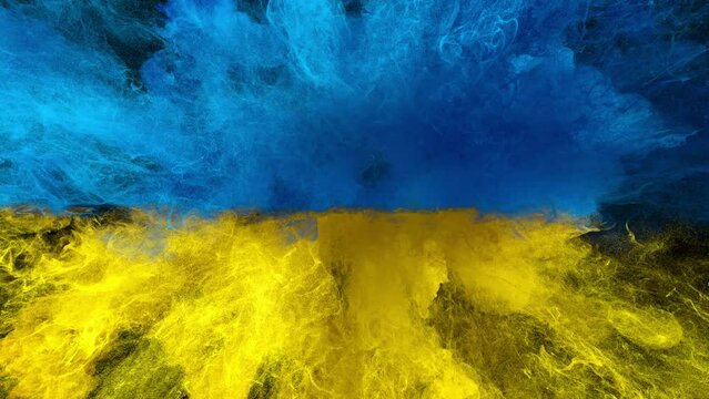 Colorful smoke powder close up explosion. Coloured yellow blue closeup fluid ink particles forming a Ukraine flag in slow motion. Isolated on black background. Alpha matte 4k.