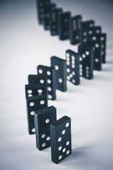 Black dominoes chain on white table background