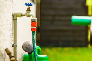 Garden tap with hosepipe attached.