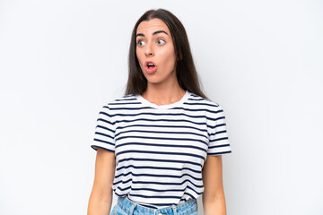 Obraz premium Young caucasian woman isolated on white background doing surprise gesture while looking to the side