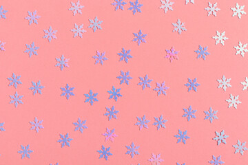 Decorative shiny blue snowflakes on a pink background. Christmas decor.