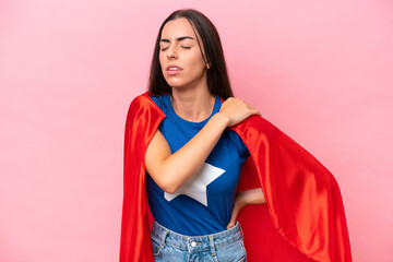Super Hero Caucasian woman isolated on pink background suffering from pain in shoulder for having made an effort © luismolinero