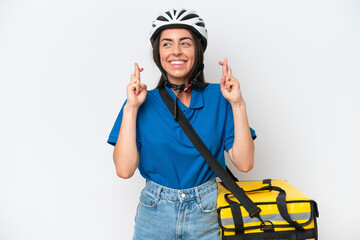 Young caucasian woman with thermal backpack isolated on white background with fingers crossing