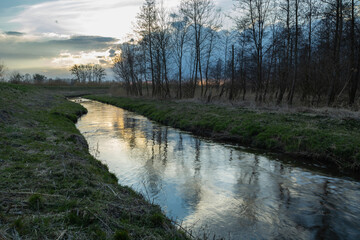 Reflection of the evening sky in a small river, Stankow, Poland