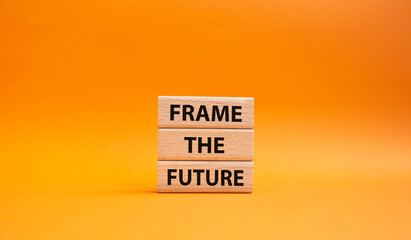 Frame the future symbol. Wooden blocks with words Frame the future. Beautiful orange background. Business and Frame the future concept. Copy space.