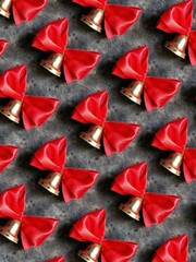 A pattern of golden bells with a red bow on a black concrete background. The concept is going to school soon. Last bell.